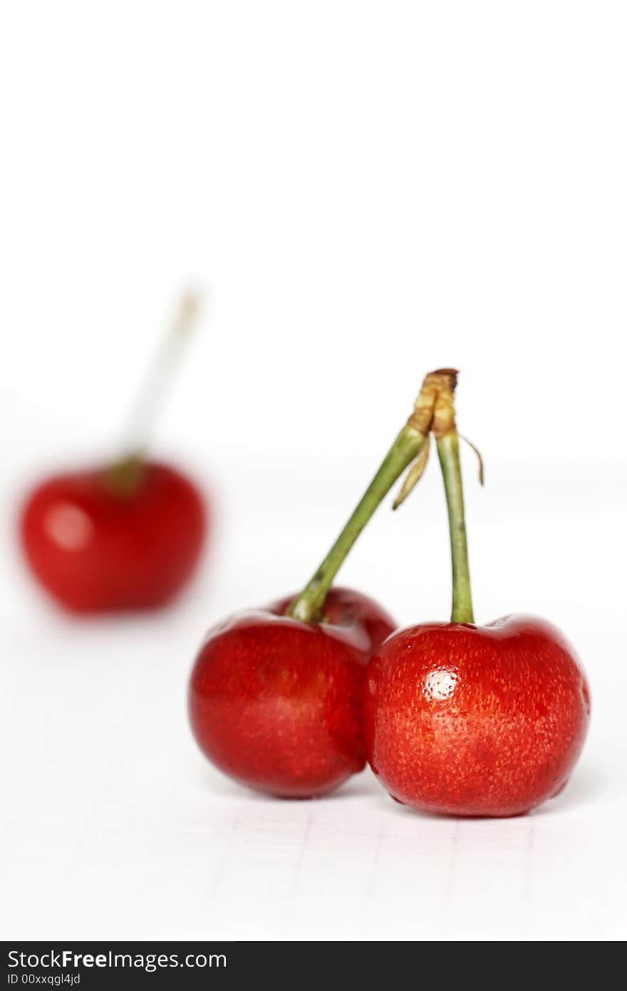 Red cherry in white background.