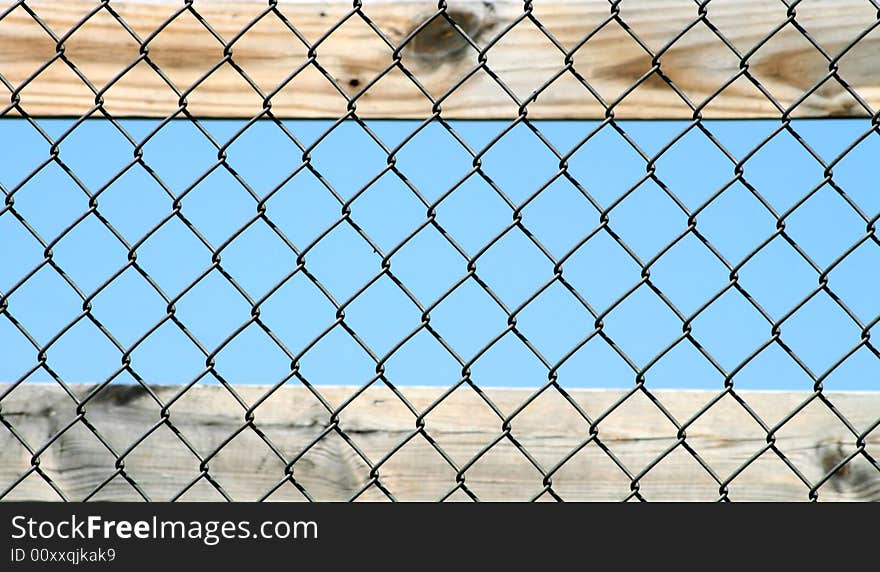 Pine board, top and bottom, with chain link fence overlay. Pine board, top and bottom, with chain link fence overlay