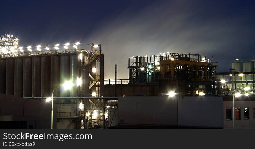 Illuminated refinery at twilight hour
