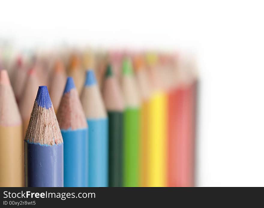 Rows of Bright colored pencils against white background