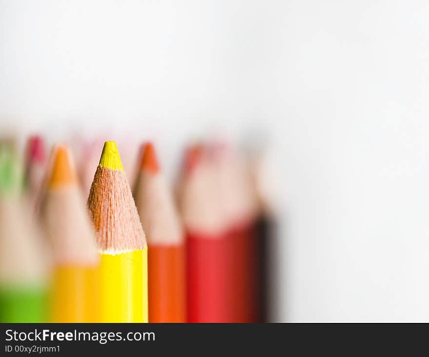 Rows of Bright colored pencils against white background