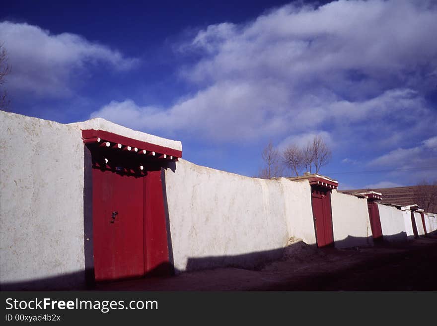 Houses of the monks in a lama temple, sichuan, china. lamas like to brush their walls white and the doors red. Houses of the monks in a lama temple, sichuan, china. lamas like to brush their walls white and the doors red.