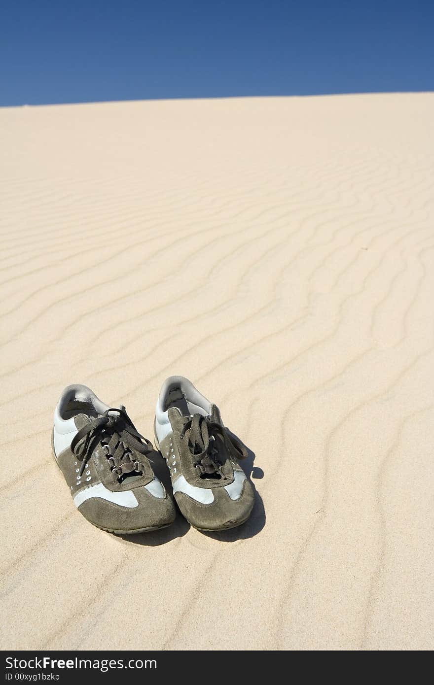 The old sneakers on sand