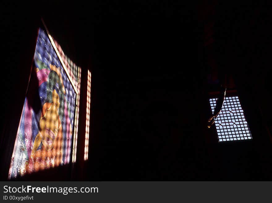 Lights cast on a picture of buddha on the wall. Lights cast on a picture of buddha on the wall