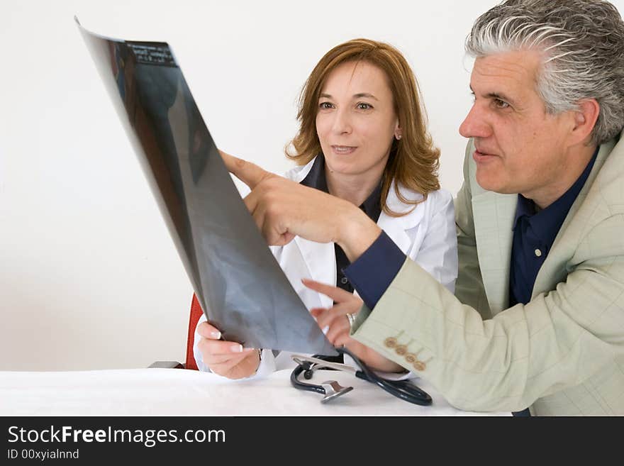 Doctors discussing a radiography of a patient. Doctors discussing a radiography of a patient