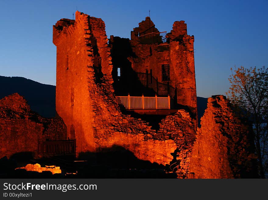 The ruins of the castle at Urquhart at night near Inverness on the banks of Loch Ness in Scotland. The ruins of the castle at Urquhart at night near Inverness on the banks of Loch Ness in Scotland