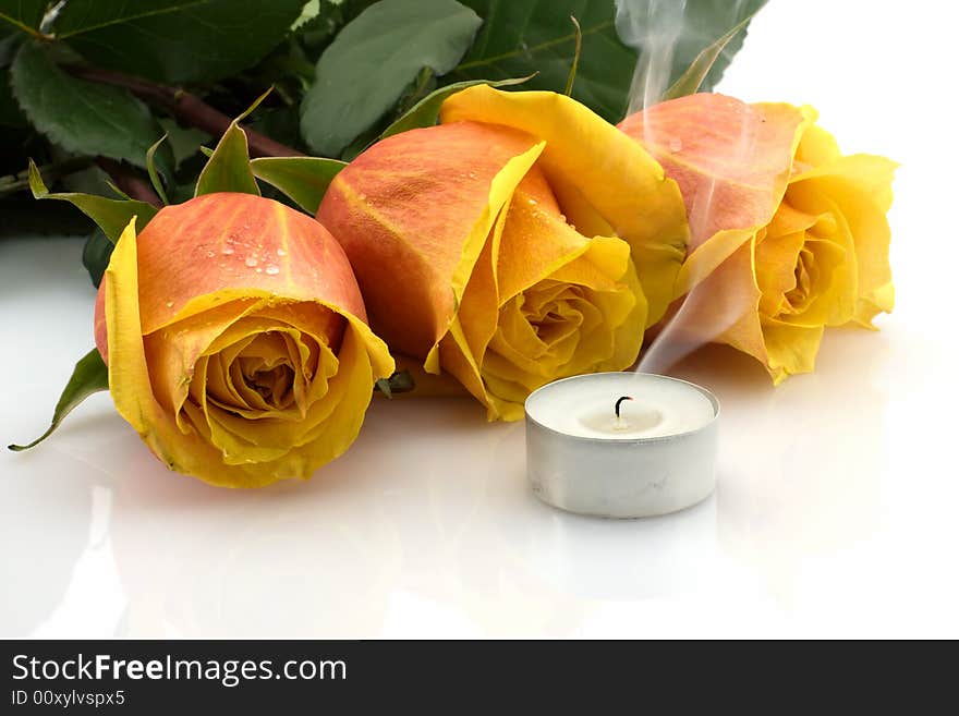 Yellow-red roses and candle blown out, reflection on white background. Yellow-red roses and candle blown out, reflection on white background