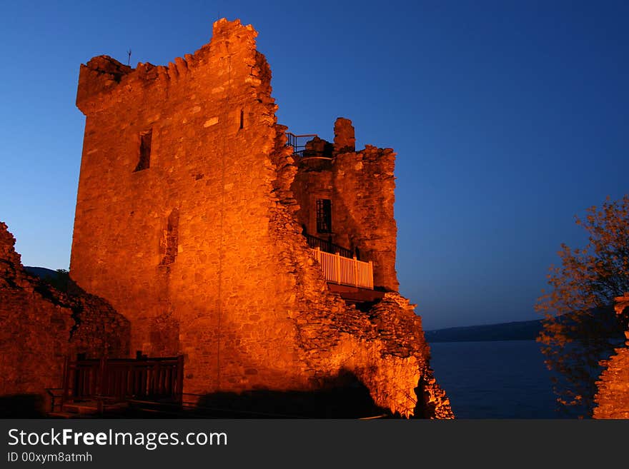 The ruins of the castle at Urquhart at night near Inverness on the banks of Loch Ness in Scotland. The ruins of the castle at Urquhart at night near Inverness on the banks of Loch Ness in Scotland