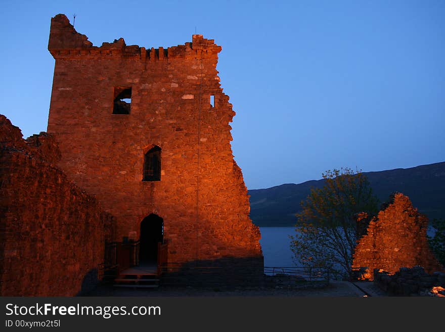 The ruins of the castle at Urquhart at night near Inverness on the banks of Loch Ness in Scotland. The ruins of the castle at Urquhart at night near Inverness on the banks of Loch Ness in Scotland