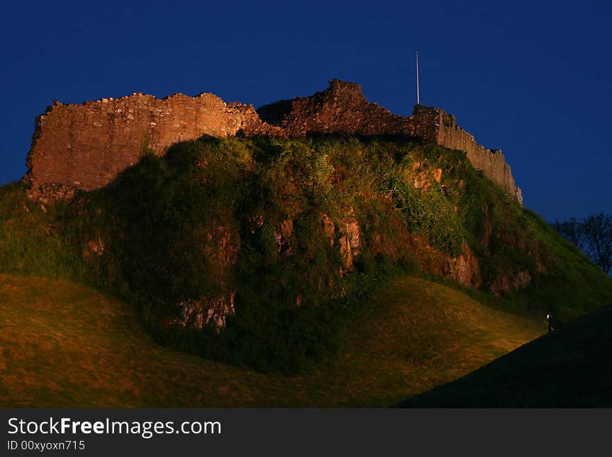 The ruins of the castle at Urquhart at night near Inverness on the banks of Loch Ness in Scotland. The ruins of the castle at Urquhart at night near Inverness on the banks of Loch Ness in Scotland