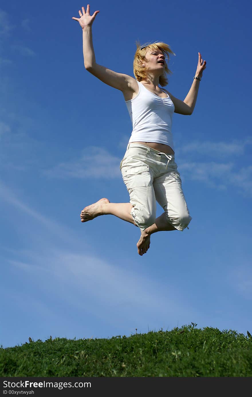 Happy woman jump in field