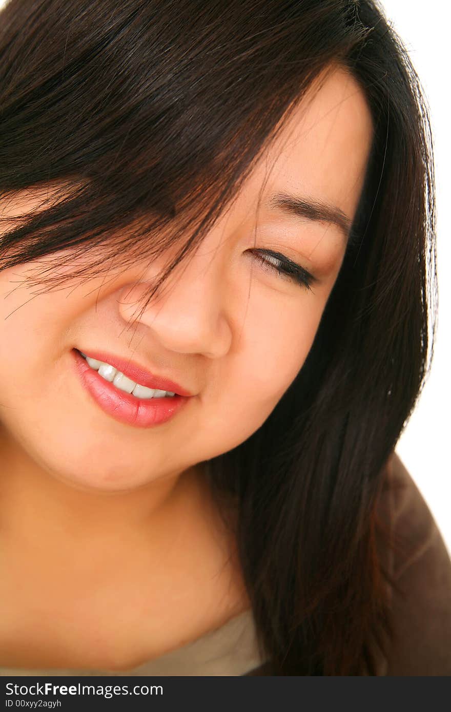 Close up of young and pretty asian girl, part of her face covered with her hair. Close up of young and pretty asian girl, part of her face covered with her hair