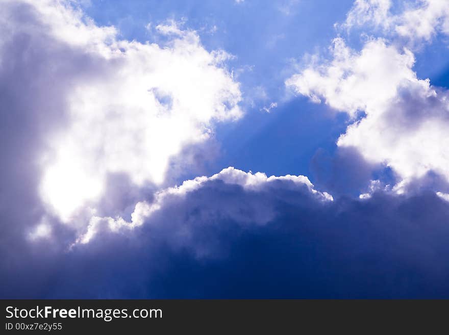 An blue sky filled with dark clouds. An blue sky filled with dark clouds.