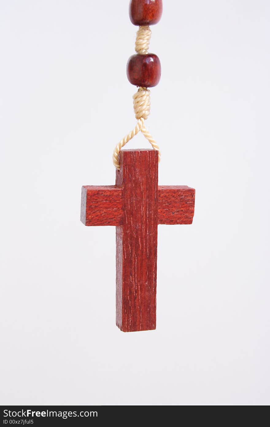 Small wooden cross on white back ground. Small wooden cross on white back ground