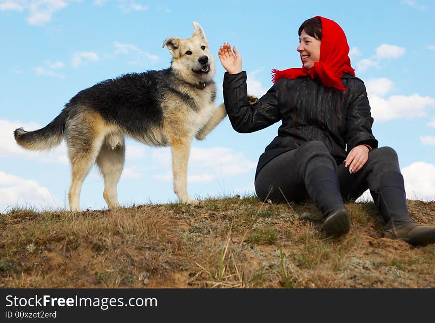 The woman and dog against the sky