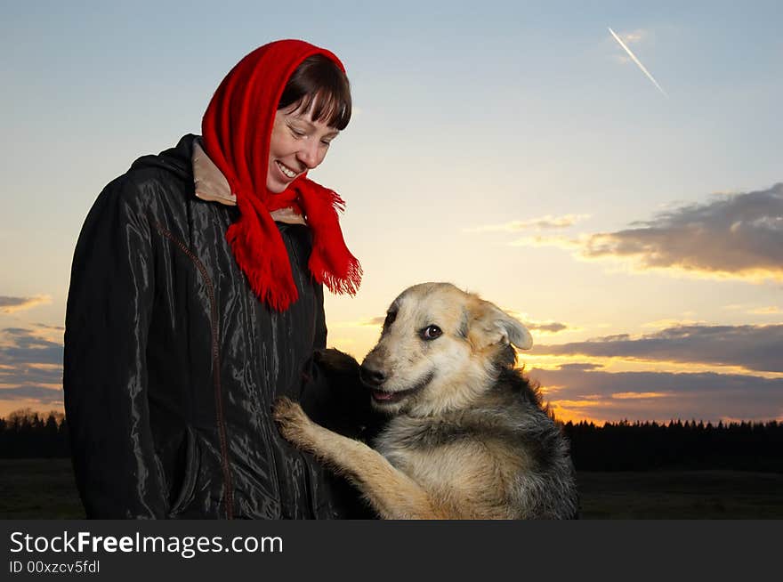 The woman and dog against the sky