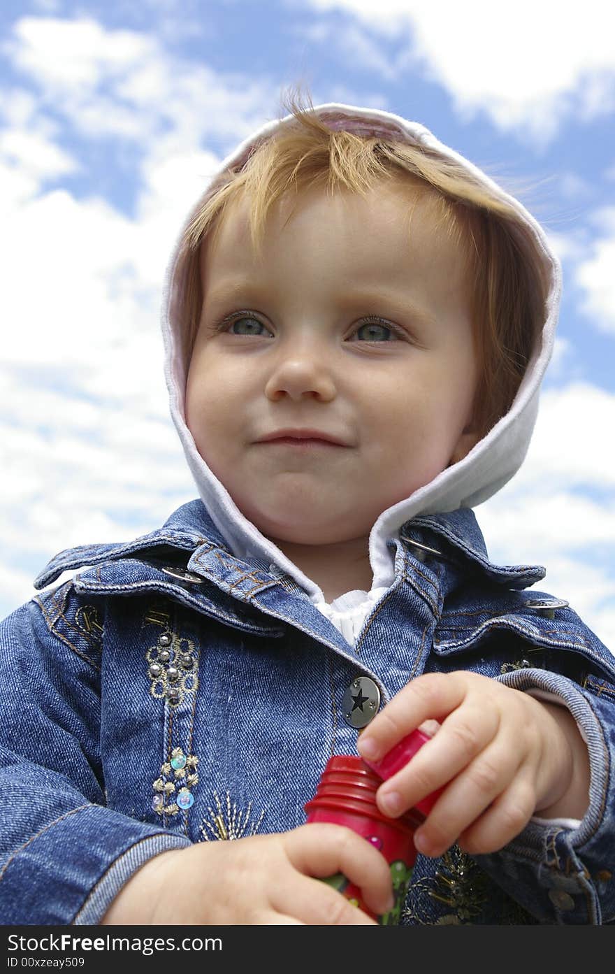 The clever little girl on a background of the sky. The clever little girl on a background of the sky