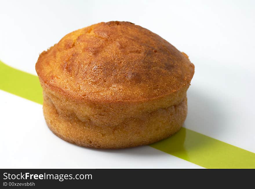 A carrot muffin in a white and green plate