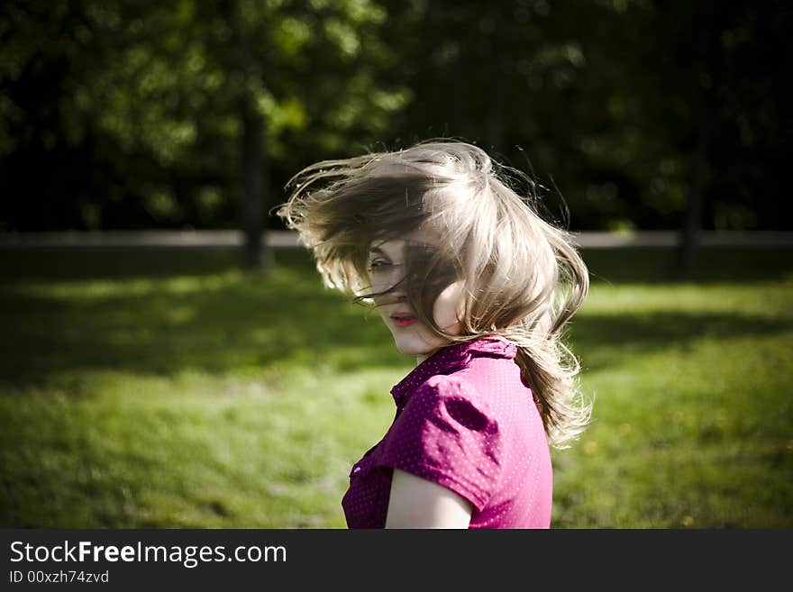 Looking Back. Young Woman In The Park.