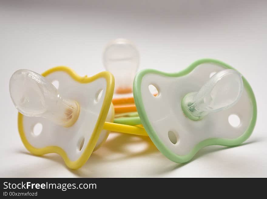 Three children's dummies on a white background green, yellow, orange