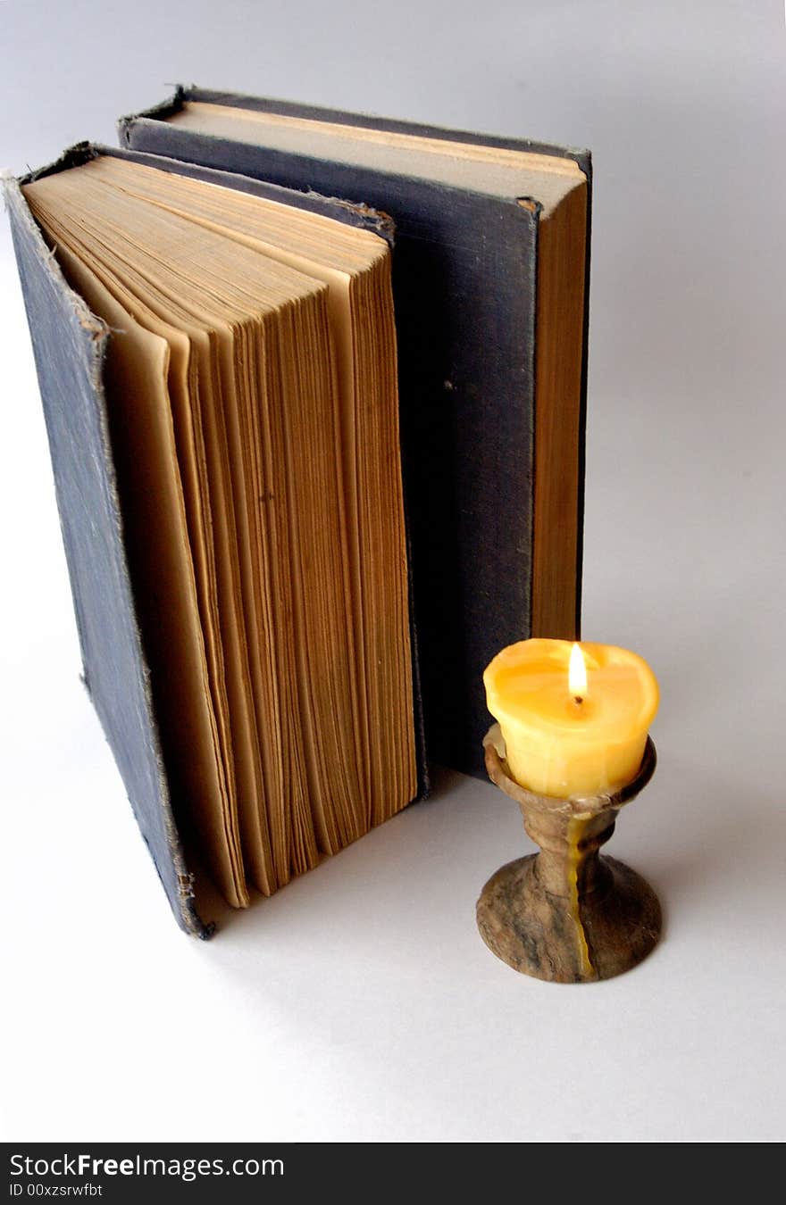 Old books with candle