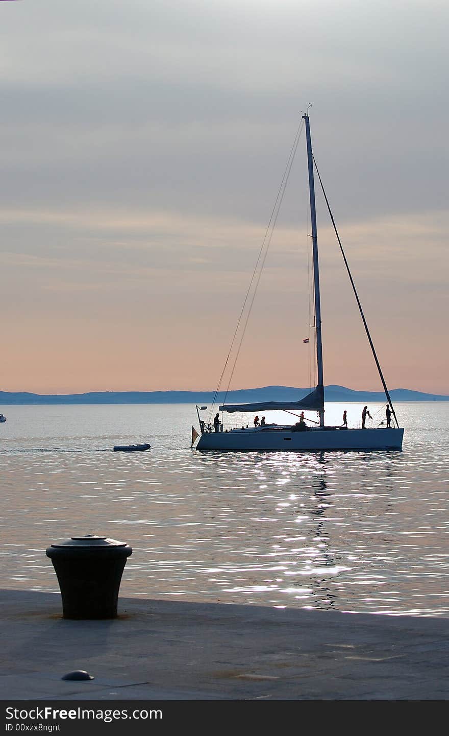 Silhouette of yacht coming into harbour. Silhouette of yacht coming into harbour