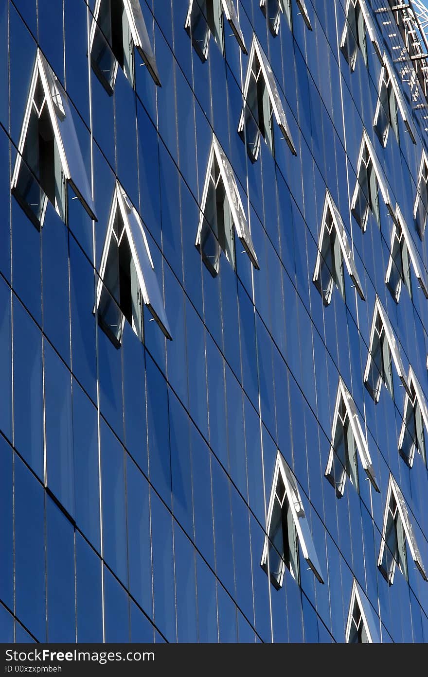 Modern skyscraper windows, reflection pattern, close-up