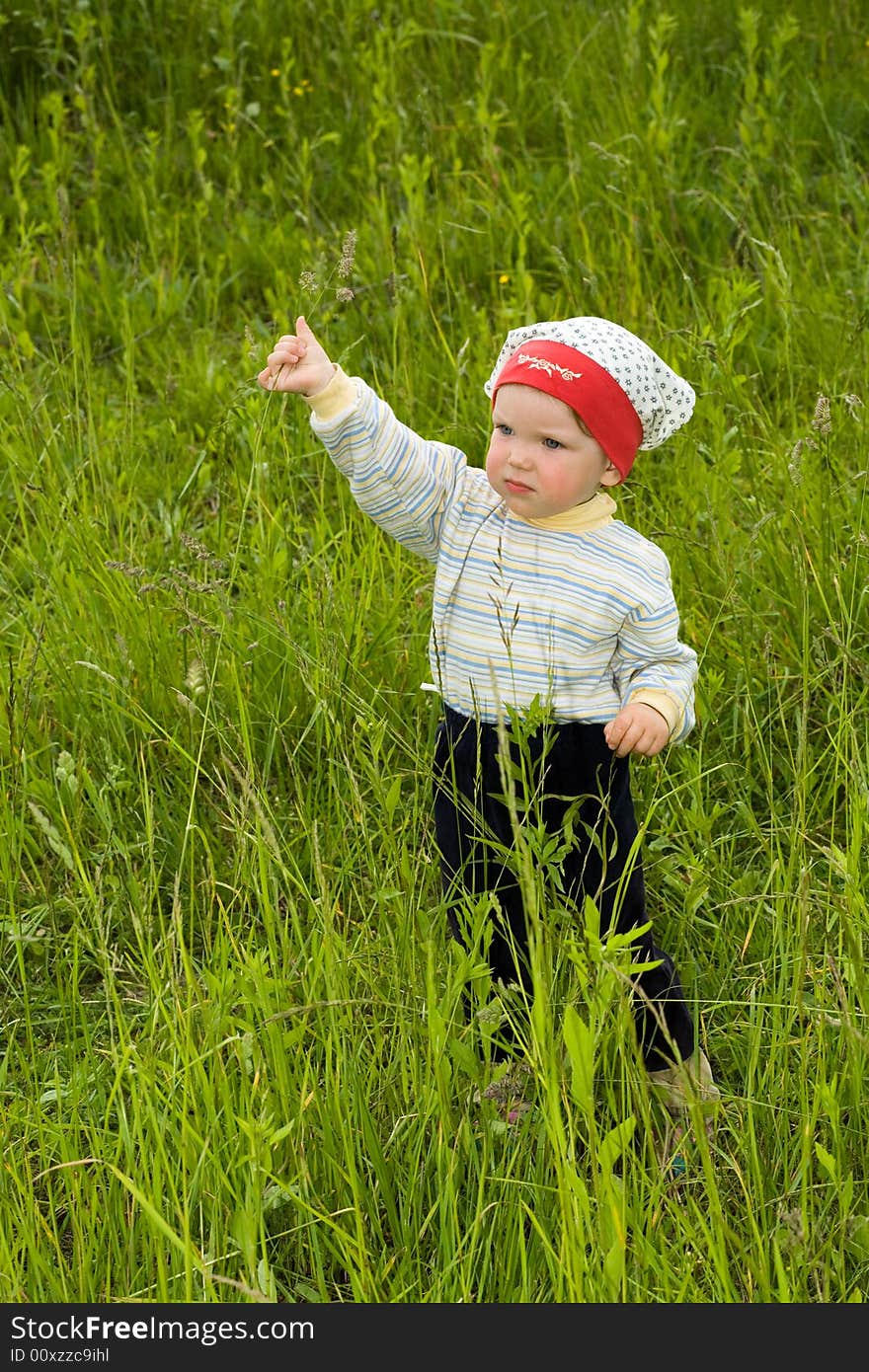 Baby in green field