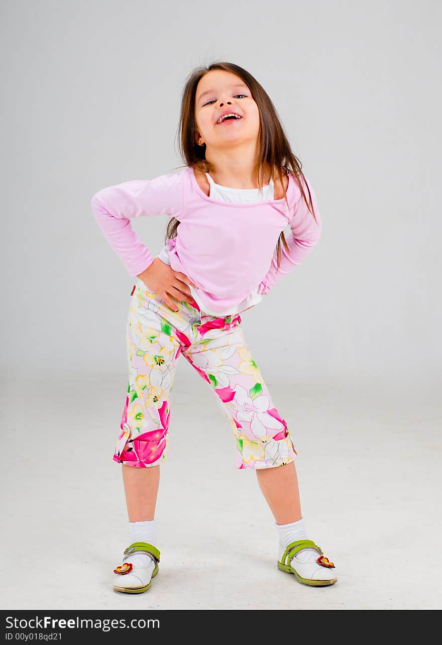 Cute smiling baby girl posing in brightly colored clothes. Cute smiling baby girl posing in brightly colored clothes