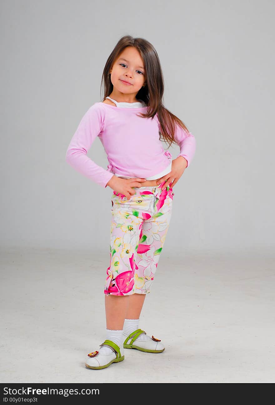 Cute smiling baby girl posing in brightly colored clothes. Cute smiling baby girl posing in brightly colored clothes