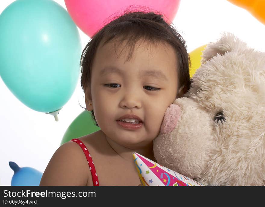 Teddy bear with a child over the balloons