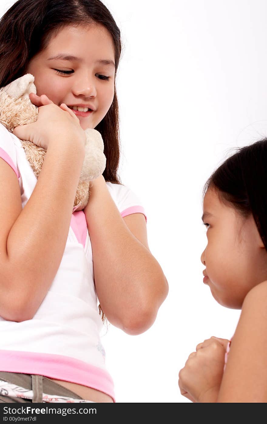 Smiling young girl holding a cute cuddly toy