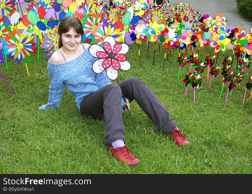 A portrait of a beautiful young girl holding a pinwheel. A portrait of a beautiful young girl holding a pinwheel