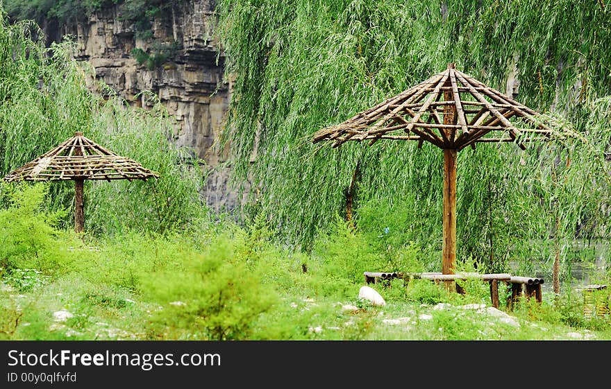 There is a old garden with dilapidated gloriette