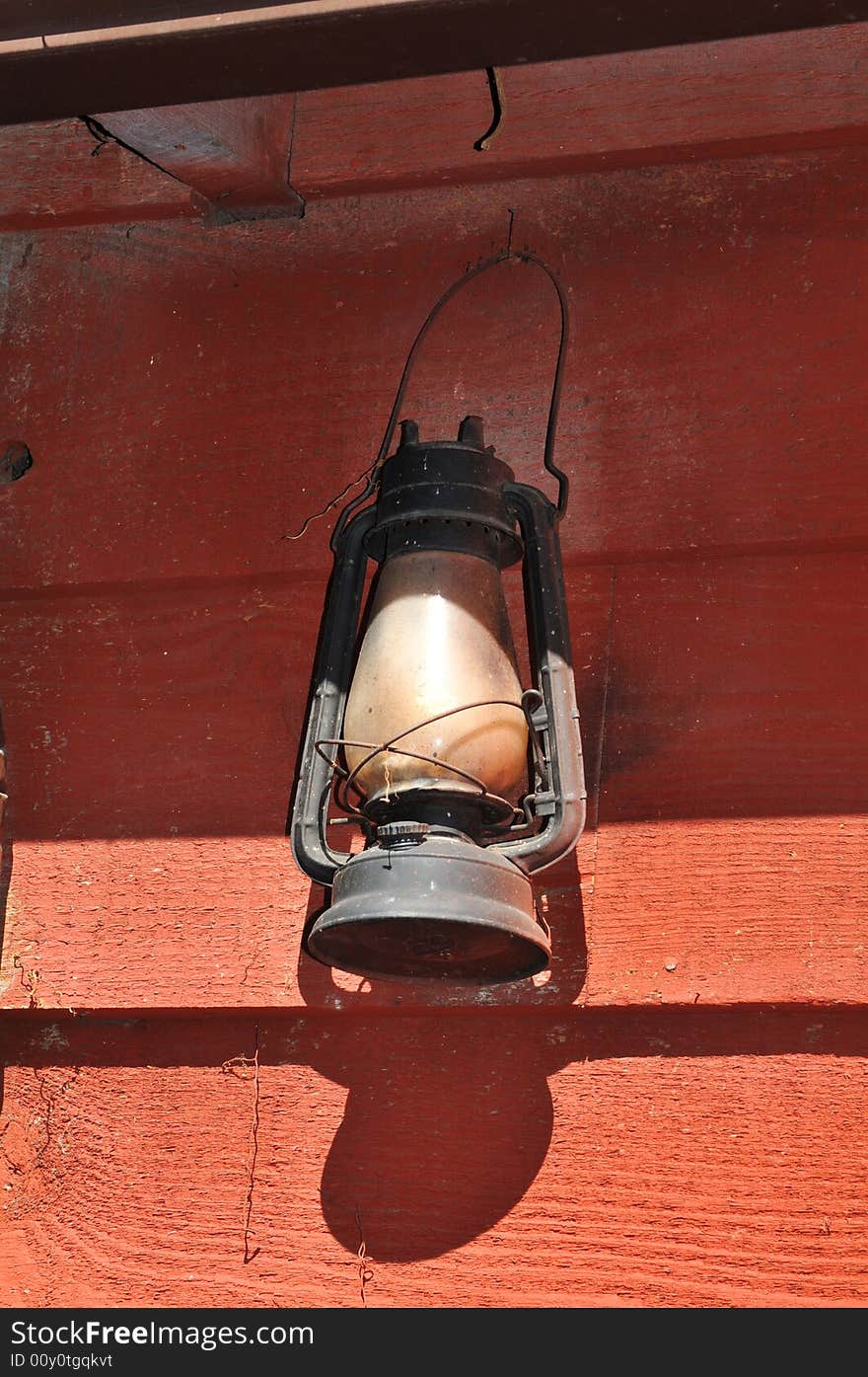 Lit Antique oil lamp against a grungee background