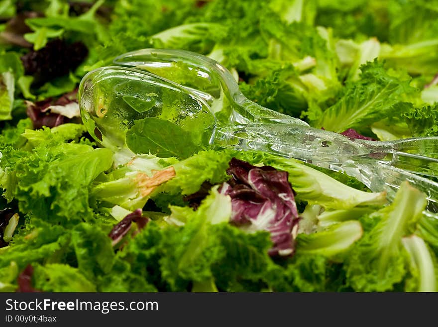 Fresh Organic Greens And Plastic Salad Tongs