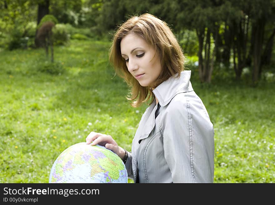 Travel Dreams. Woman Looking On The Globe.