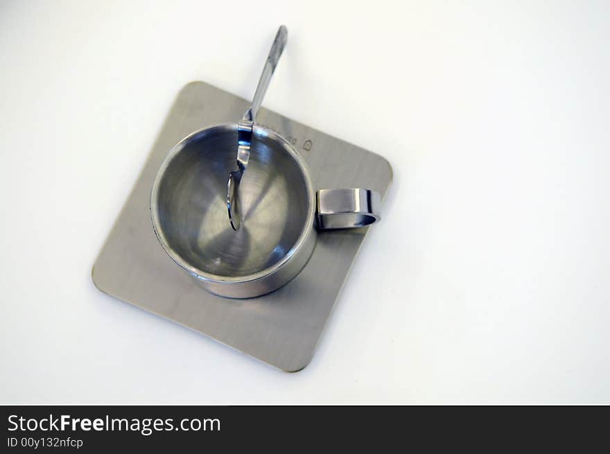 The shiny stainless steel plate , spoon and cup for drinking. The shiny stainless steel plate , spoon and cup for drinking.
