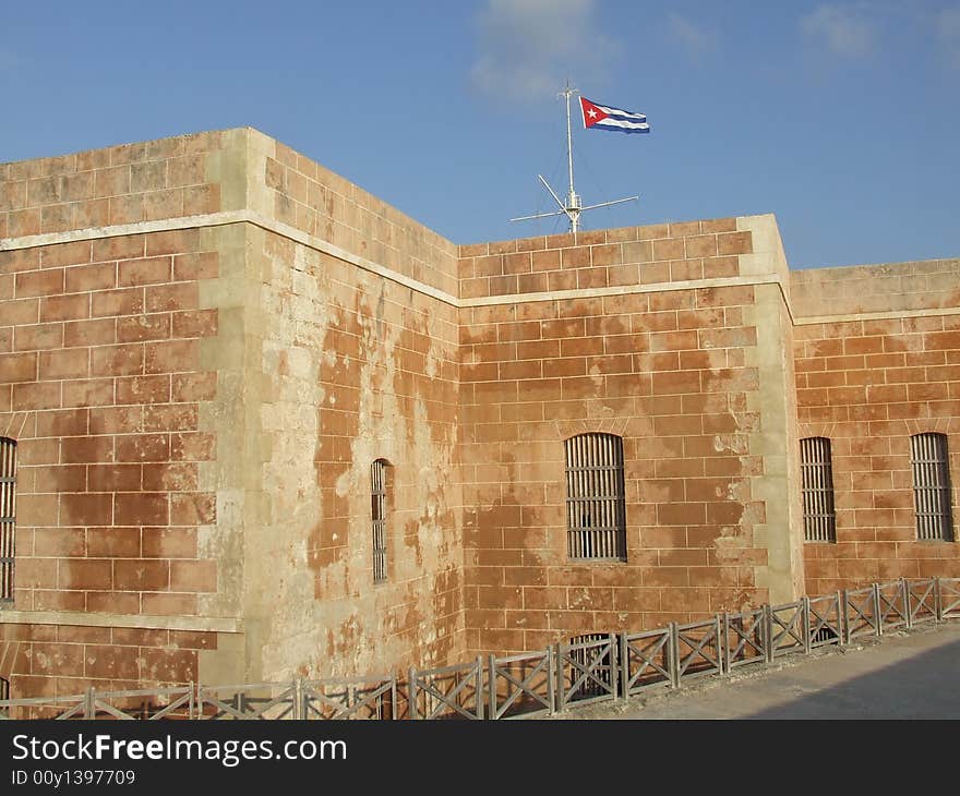 The Morro bricks wall and a cuban flag, in Havana Cuba