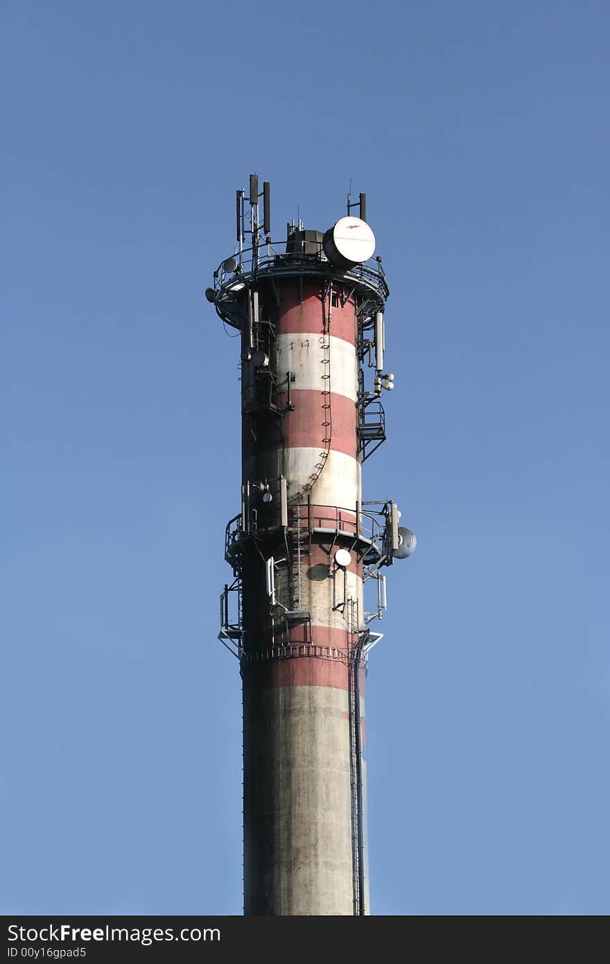 Close - up of chimeny over blue sky.