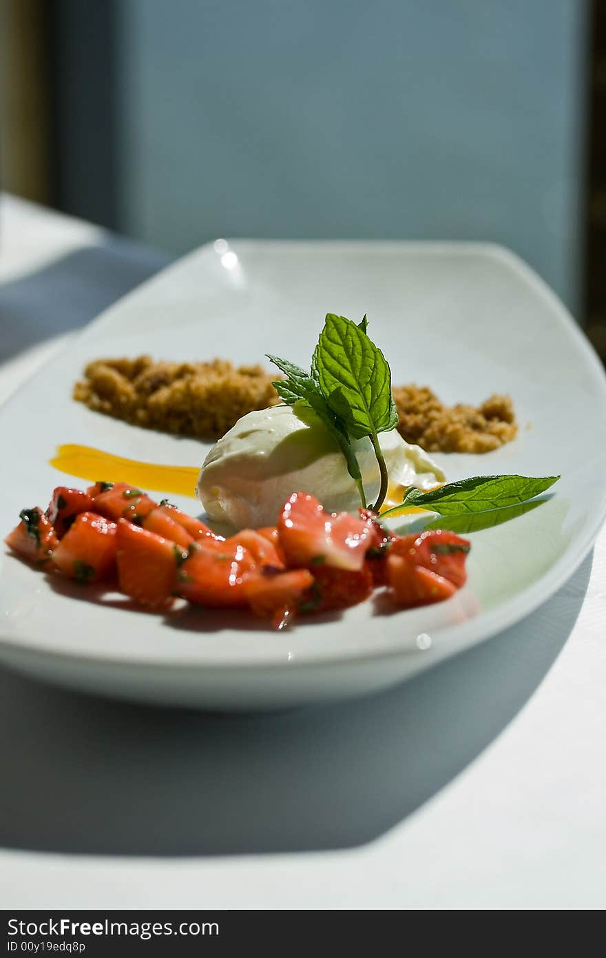 A dessert made of icecream and strawberrys. A dessert made of icecream and strawberrys