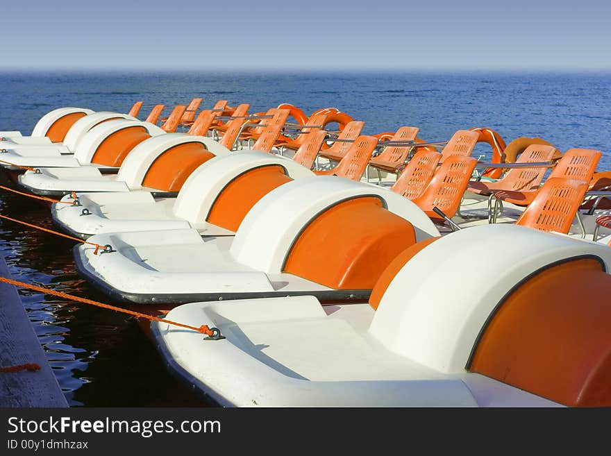 Colorful catamarans on leash