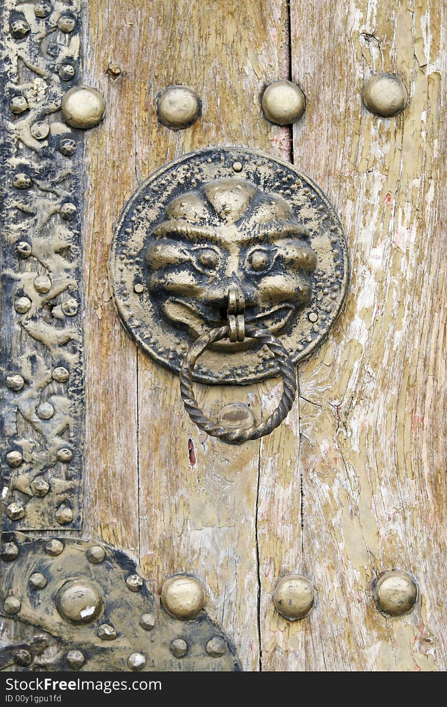 Ornamental knocker on the ancient door.