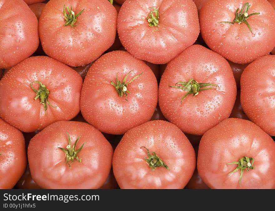 Wet organic tomatoes filling the frame