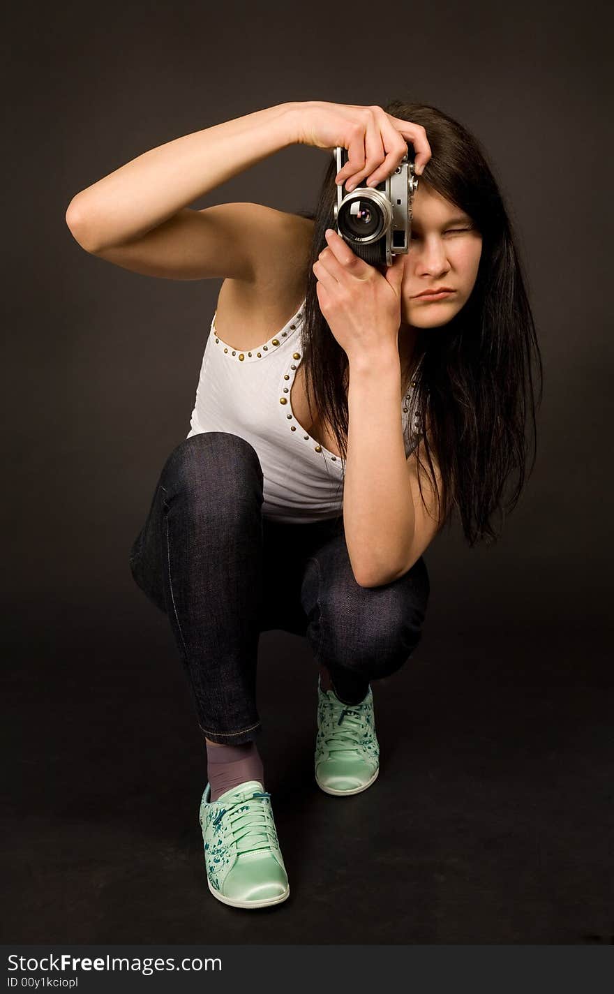 Young girl posing with old camera isolated on black background. Young girl posing with old camera isolated on black background