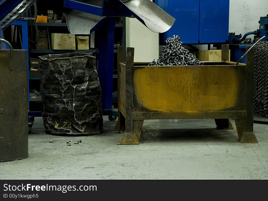 Parts of chains comming out of a machine in the factory. Parts of chains comming out of a machine in the factory