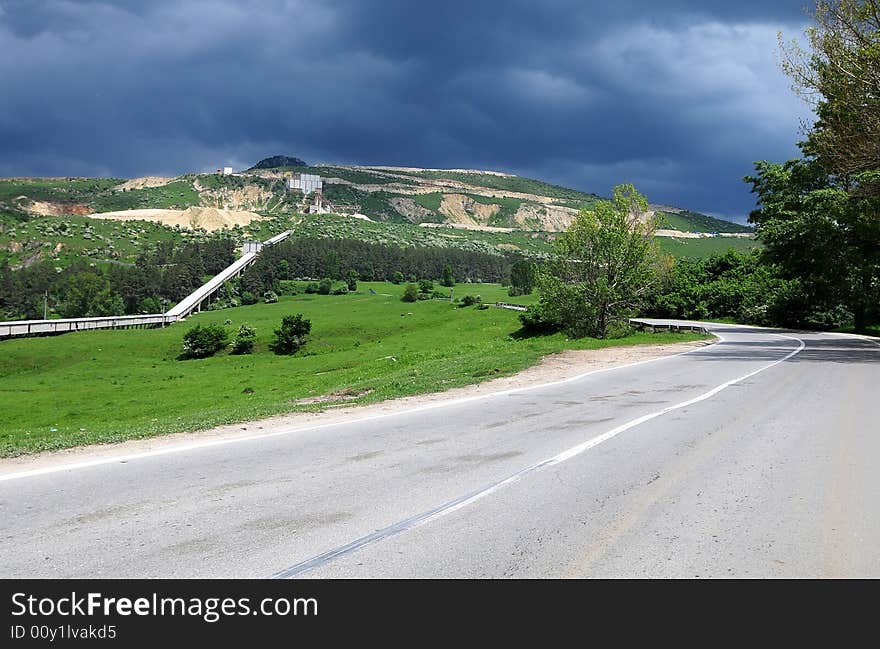 A road is taking us to the mountains and the storm is coming