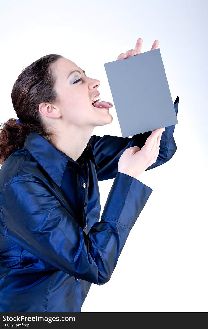 Portrait of a woman with long curly hair putting her tongue against a grey card. Portrait of a woman with long curly hair putting her tongue against a grey card