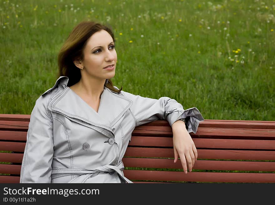 Young Woman Sitting On The Bench. Young Woman Sitting On The Bench