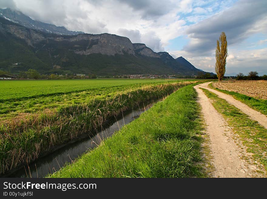 Wide angle shot of a rural track in the gresivaudan valley. Wide angle shot of a rural track in the gresivaudan valley